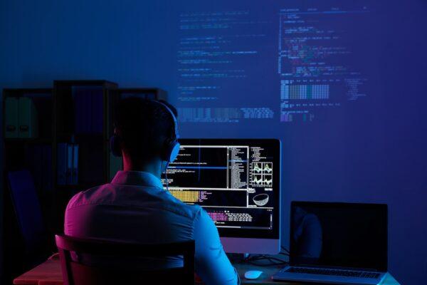 rear-view-programmer-working-all-night-long (2) The Ultimate Guide To Build Custom ERM Software From Scratch